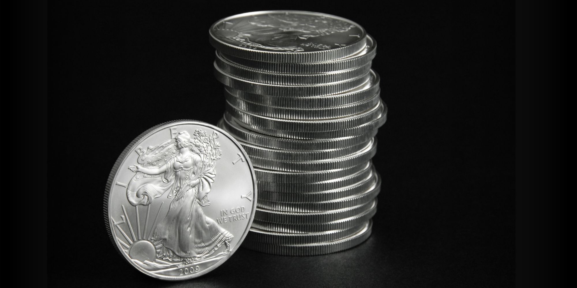 A stack of Silver Eagles on a black background