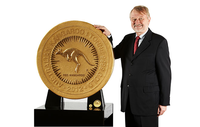 A man standing beside the world’s largest coin
