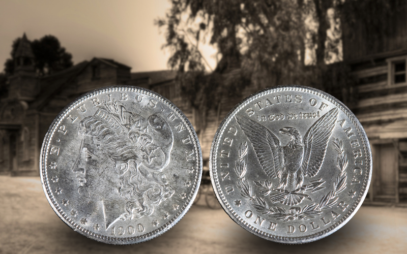 Front and back of a Morgan Dollar minted in 1900 with a picture of a frontier town in the background